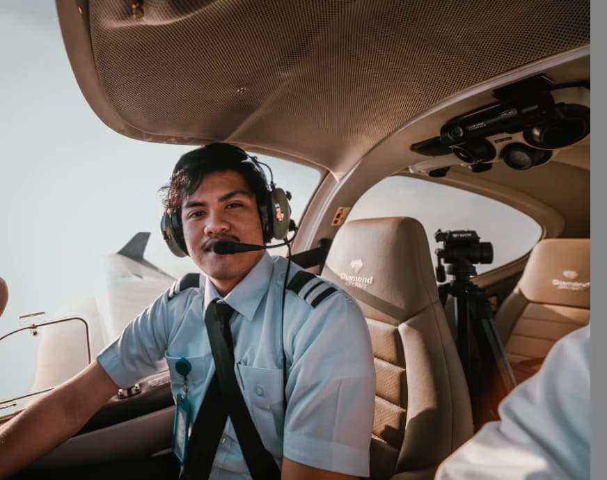 The camera and tripod position visible behind Raden in the aircraft cabin.